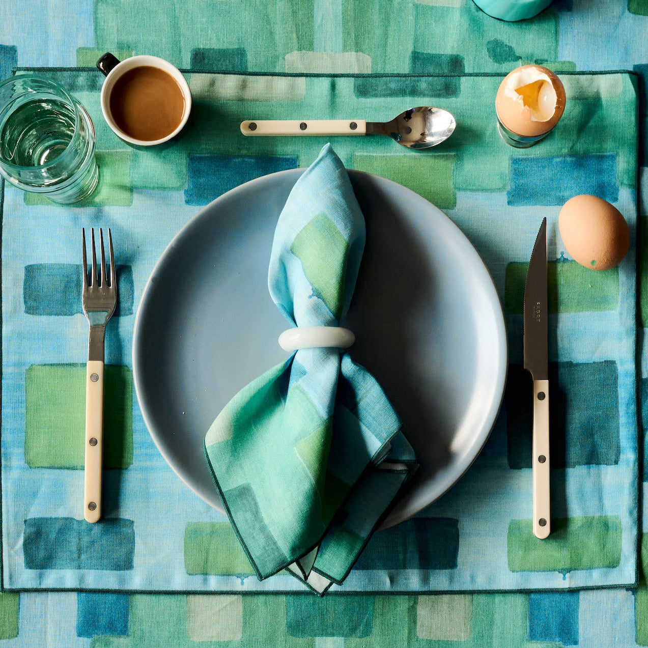 Blue Tapestry linen placemat styled on dining table setting - Goldie Home
