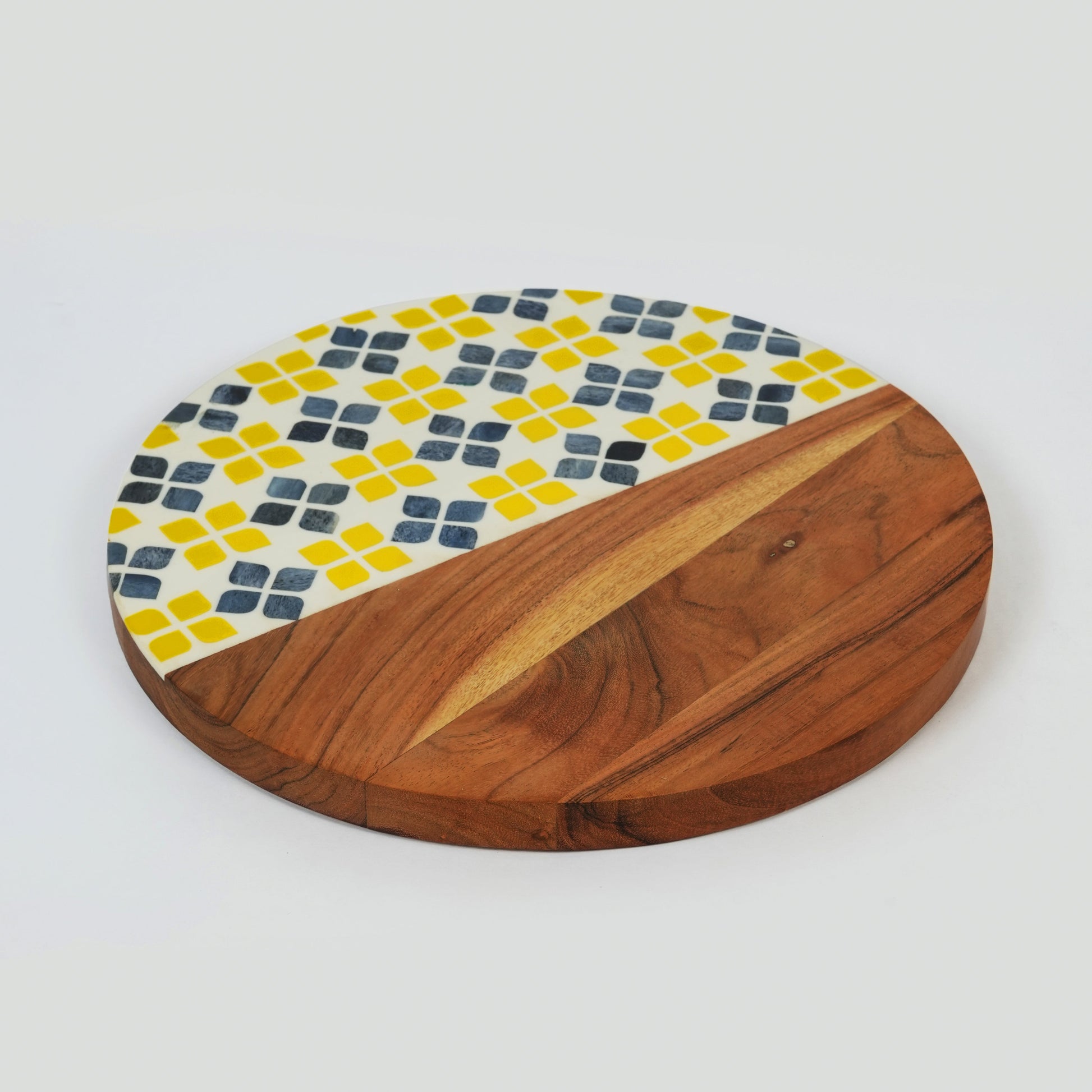 Overhead view of a 13-inch round acacia wood serve board featuring a vibrant yellow and white mosaic pattern.