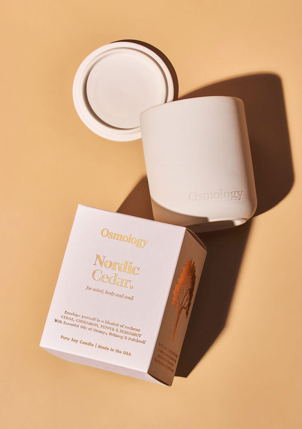 Nordic Cedar candle displayed next to product packaging