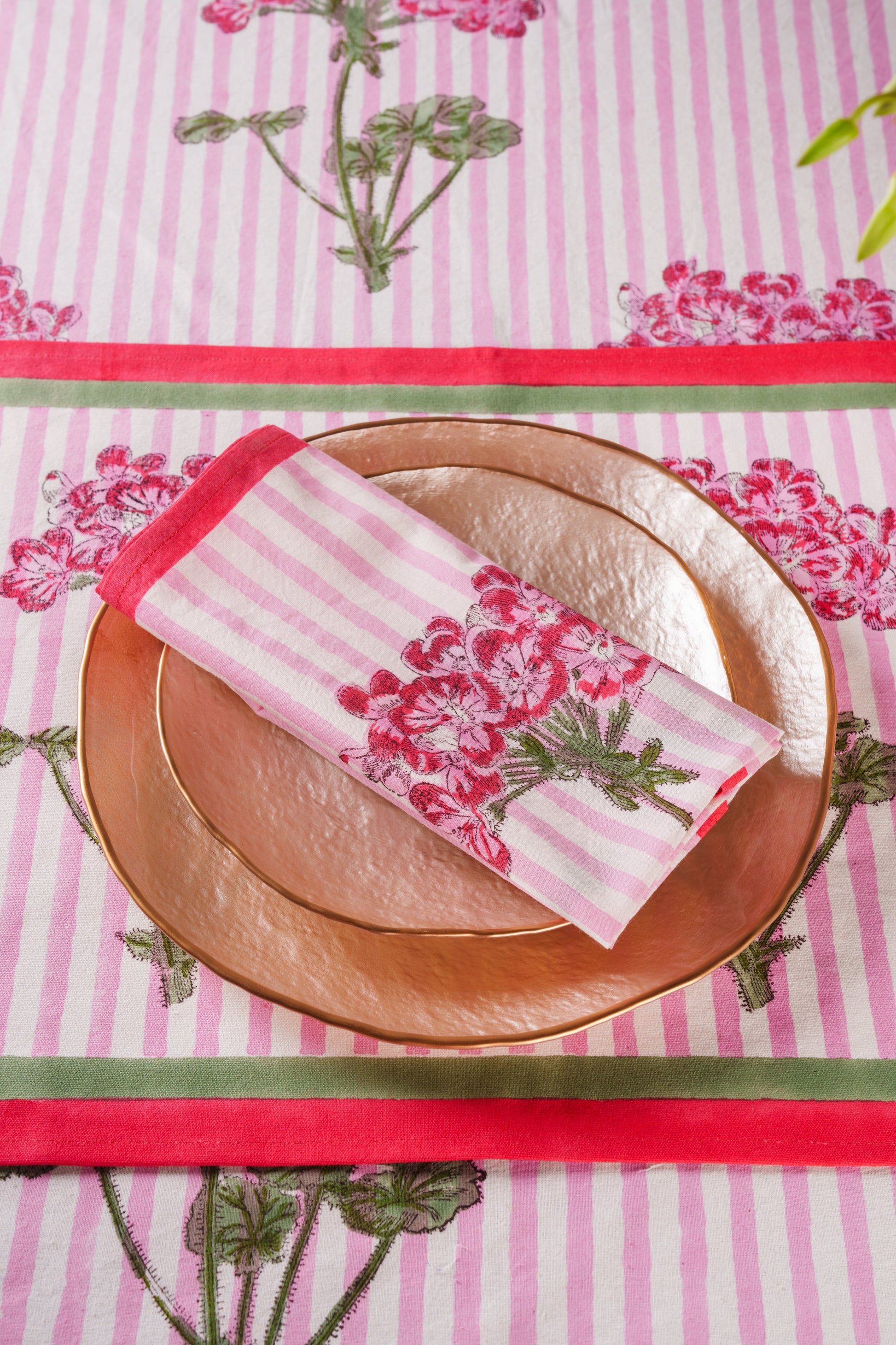 Pink striped napkin with hydrangea print on copper plates