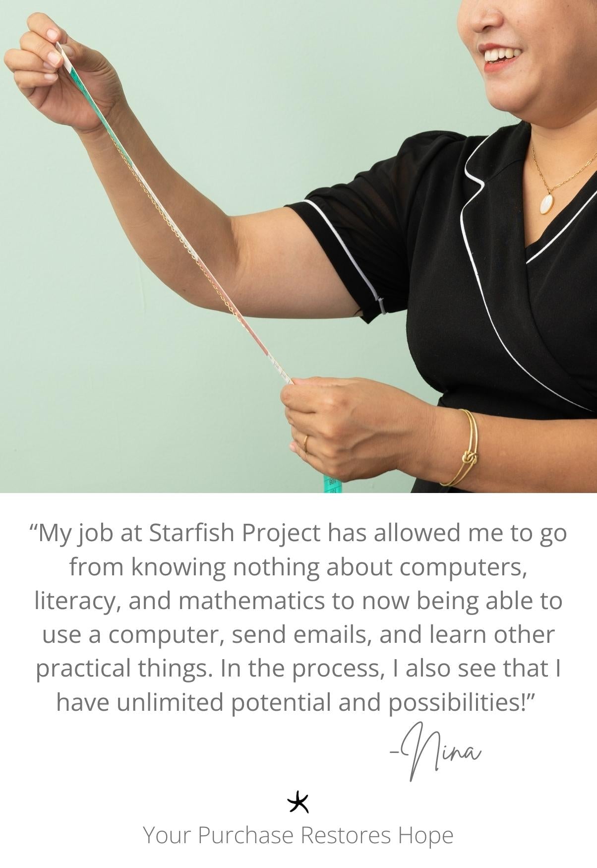 Woman smiling while wearing gold necklace with gold chain, a gold bracelet, and gold earrings with a pearl pendant, women's fair trade artisan jewelry, symbolism of hope, Starfish Project, jewelry website