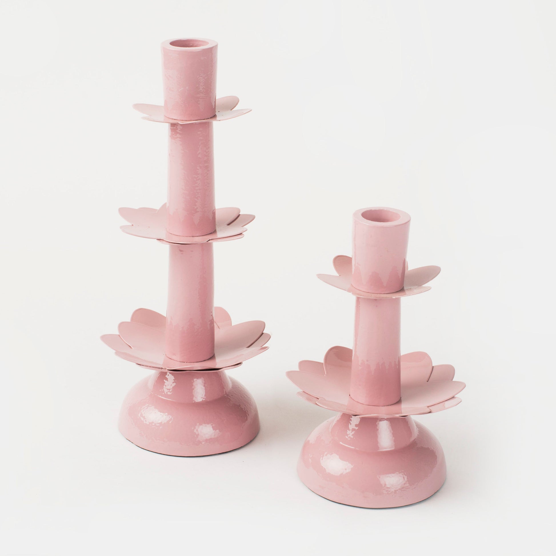 Elegant celebration setting featuring a soft pink floral-inspired taper holder and sparkling wine for a romantic brunch.