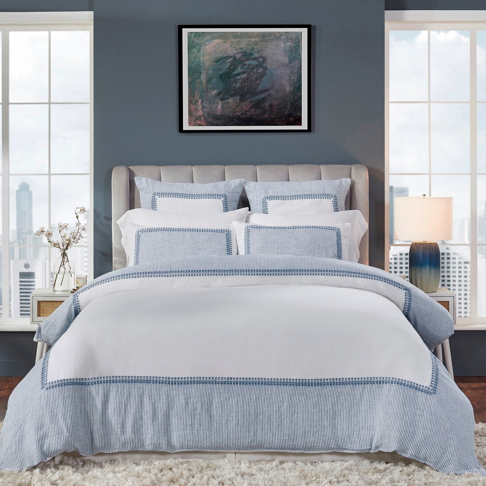 DT-030-9092_1|Elegant white duvet cover featuring a sophisticated blue striped border with intricate embroidery, creating a chic, inviting bedroom.