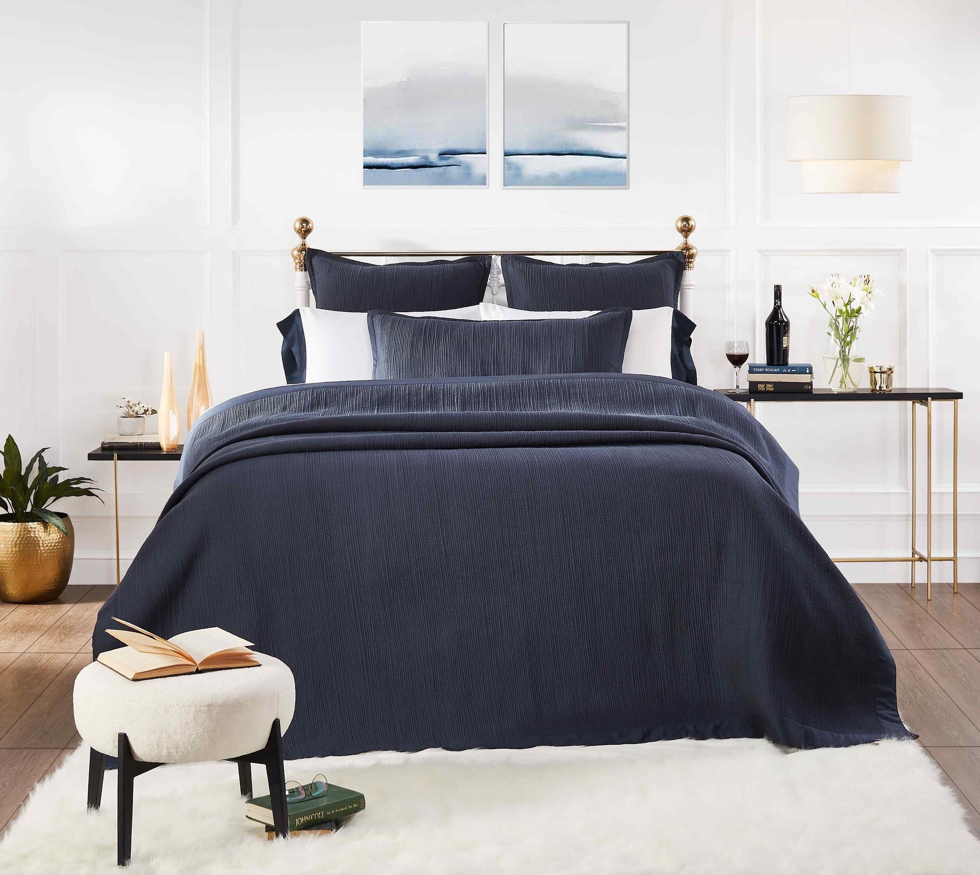 CL-158-DUP-X_1|Navy blue textured coverlet draping elegantly over a bed, offering a cozy and stylish layer for modern bedroom aesthetics.