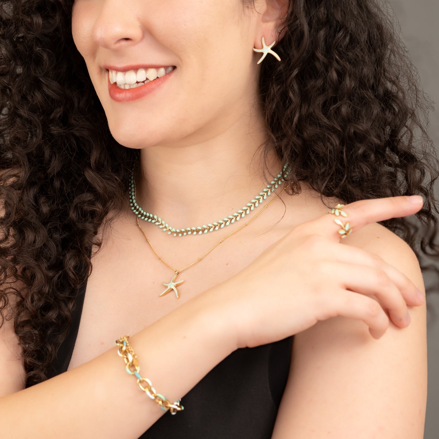 Woman wearing matching starfish themes jewelry set, mint green jewelry pieces, jewelry websites for women