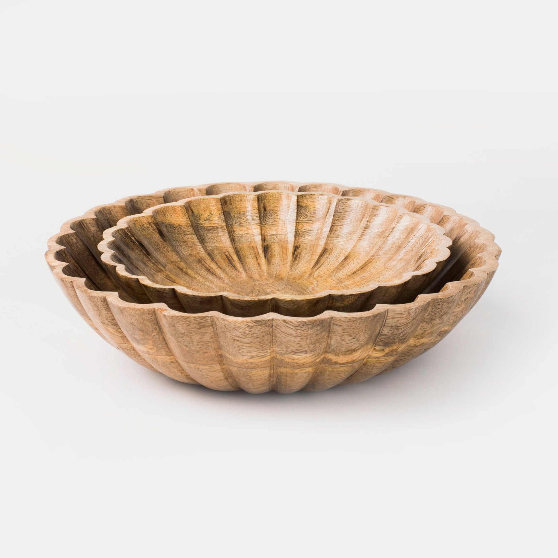 Set of two hand-carved scalloped mango wood bowls nested together