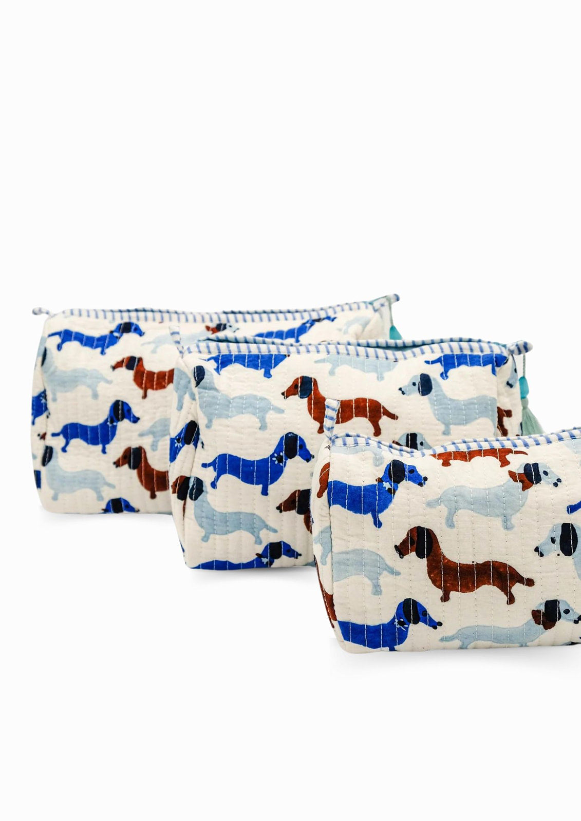 Three dashing doxies toiletry bags with colorful dachshund patterns, zipper details