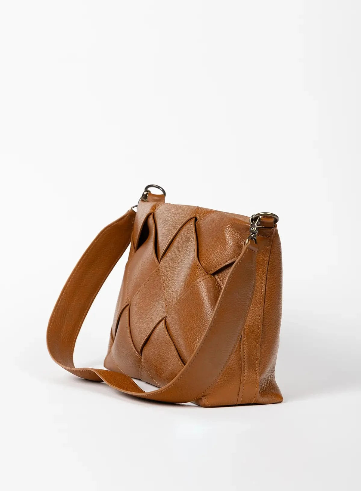 Honey leather handbag with woven design on a white background