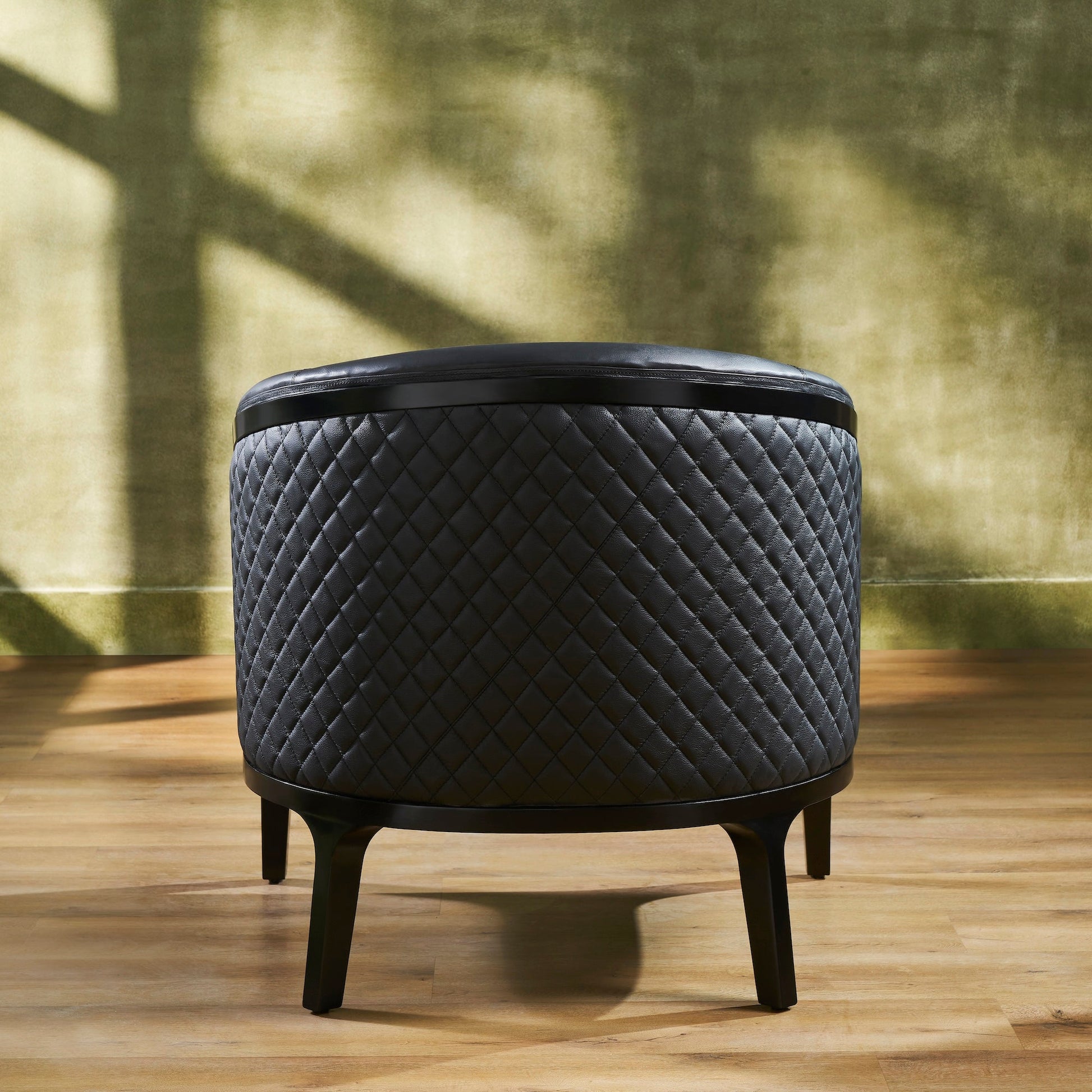 FN-5205-343329_5|Sophisticated black leather round ottoman with diamond quilted pattern and dark wooden legs, a versatile accent piece.