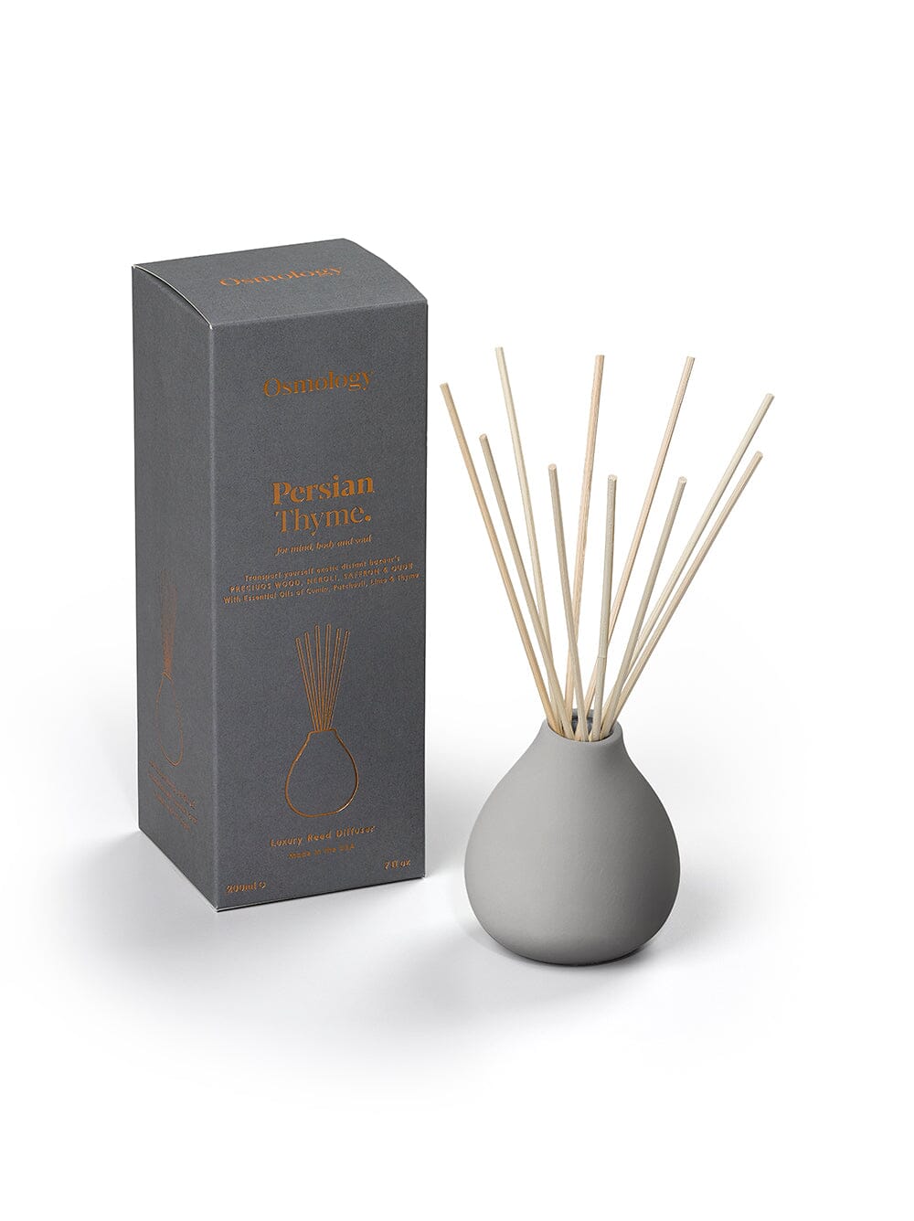 Osmology Persian Thyme grey ceramic reed diffuser next to product packaging on a cream background