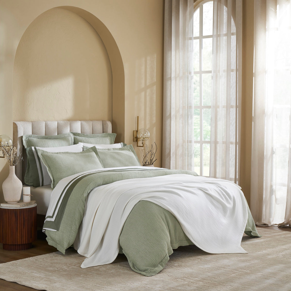 BL-861-11096_3|Soft white crinkle cotton blanket draped over a sage green bed, perfect for lightweight and breathable layering in a bedroom.
