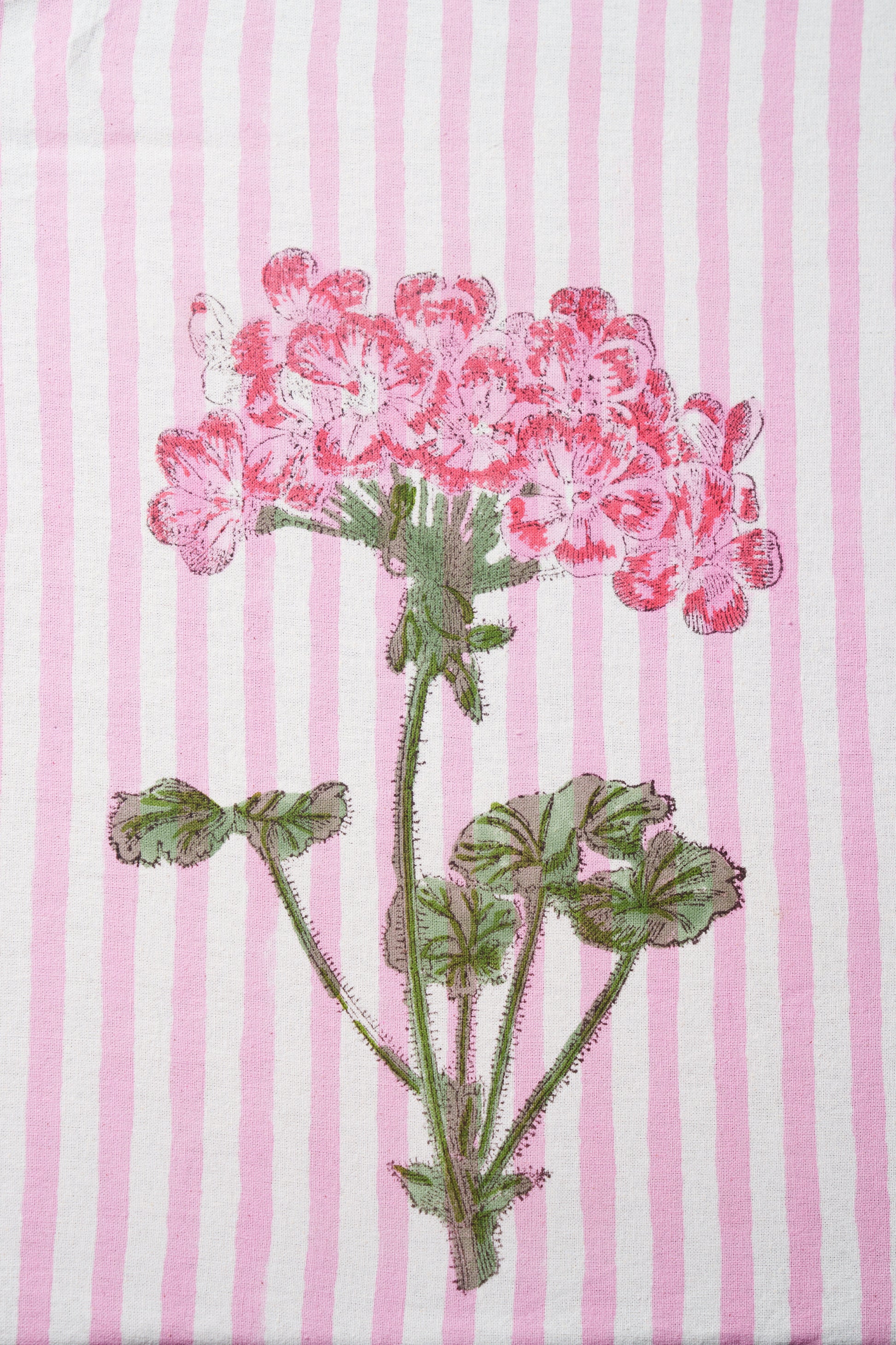 Close-up of pink hydrangea blockprint design on striped fabric