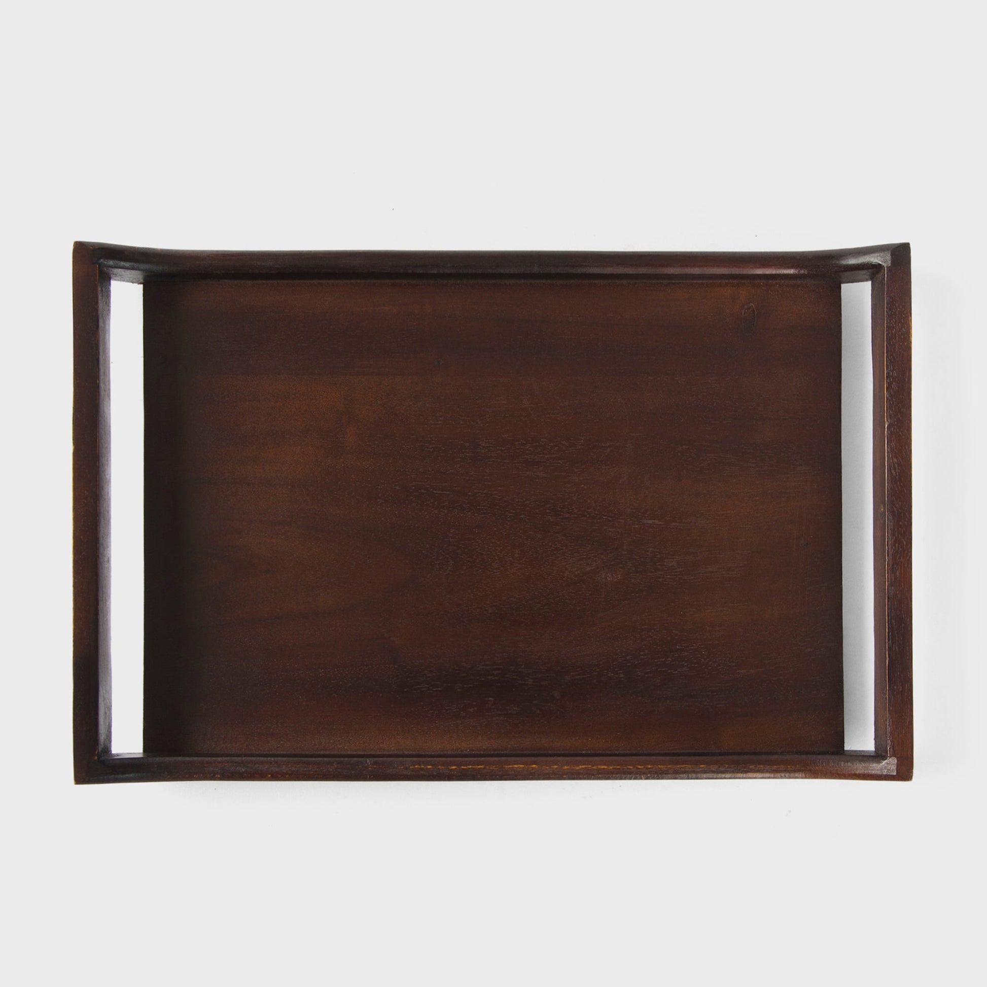 Close-up of urban walnut acacia wood grain and curved handle design on serving tray