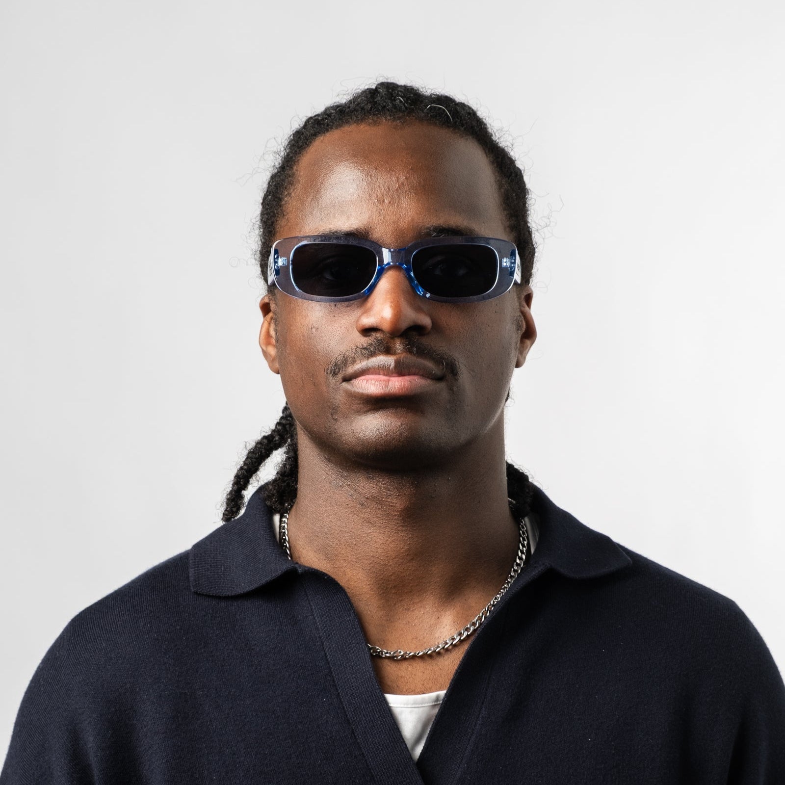 Male wearing Sad Eyewear Bouquet rectangle sunglasses in arctic blue with black tinted lenses