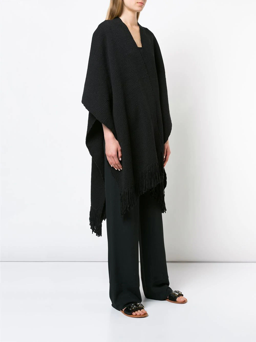 Model wearing a black Cotton Duna Fringe Duster poncho with fringe