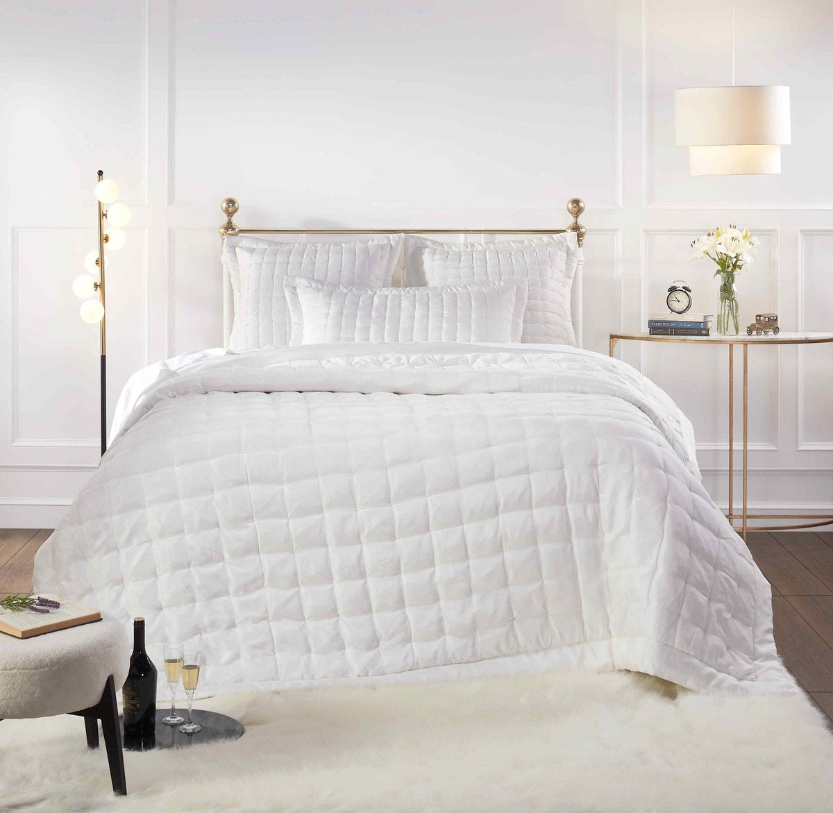 QT-332-X_1|Luxurious white quilted pillow with a distinct square pattern, complementing a crisp, modern bedroom ensemble.