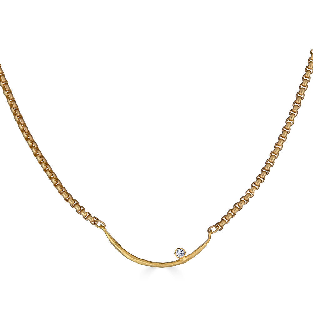 Gold curved bar necklace with a single crystal accent on a box chain.