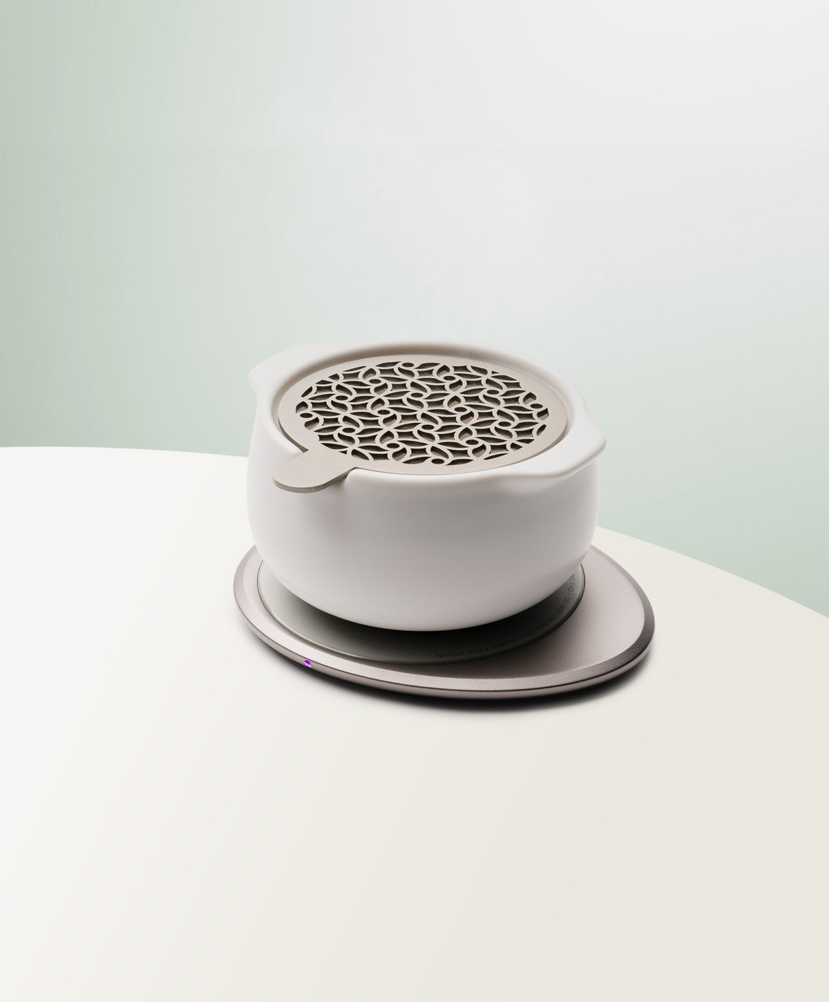 Jun Self-Heating Ceramic Diffuser 5 fl oz / 150 mL with lid in Jasmine White angled view on Ohom Pad 3 