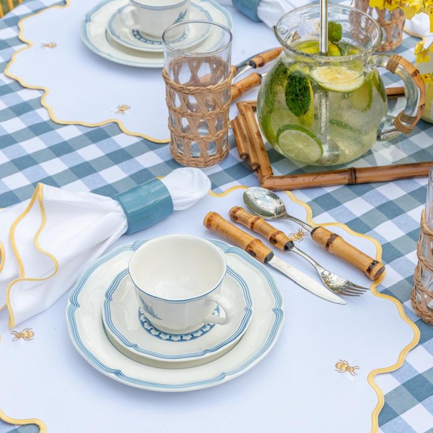 Bumble bee impermeable placemat with hand-stitched bee embroidery and yellow wavy border by Talah Home