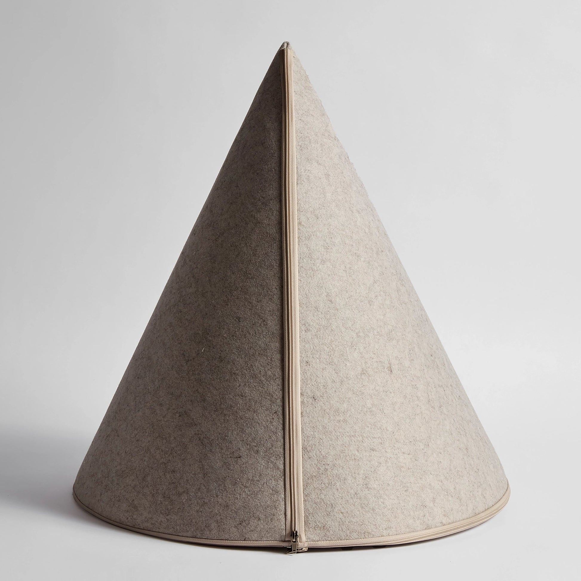 Rear view of the Nooee Pet Harry Cave in cream, showcasing its structured cone shape and full-length zipper.

