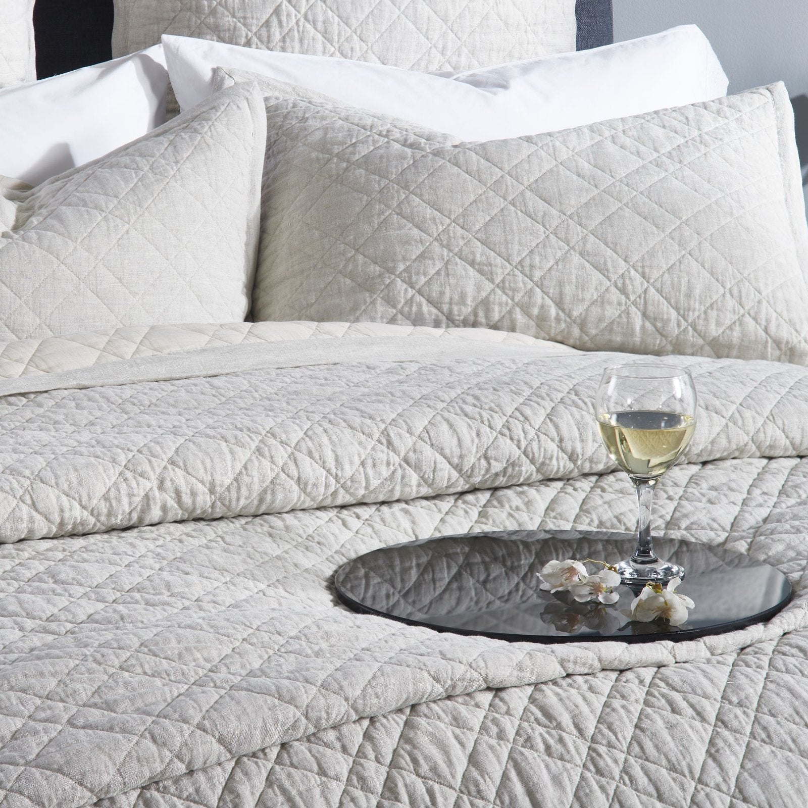 CL-254-9496_4|Luxurious beige quilted coverlet on a bed with pillows and a drink. Perfect for a cozy and elegant bedroom ambiance.