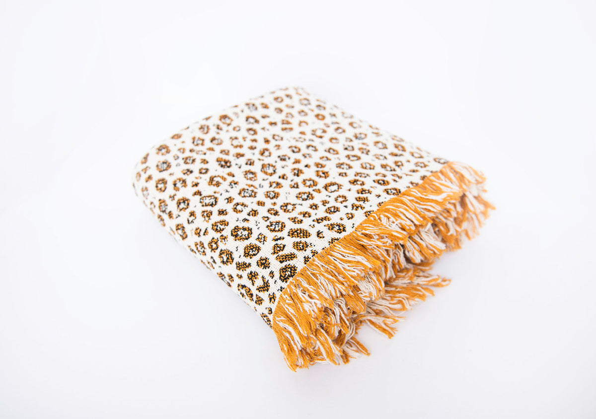 Folded Zola golden leopard-print reversible jacquard woven throw blanket