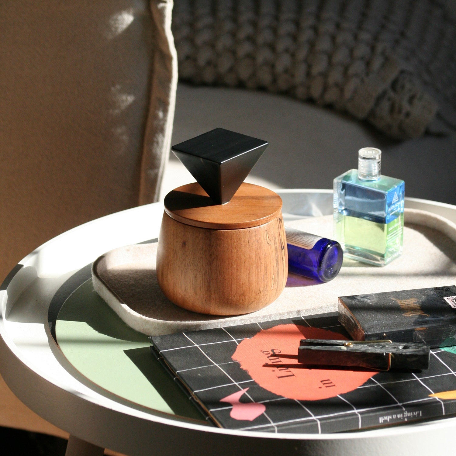 Decorative black onyx stone jewel box emphasizing its deep tones and sculptural volume in a minimalist setting.
