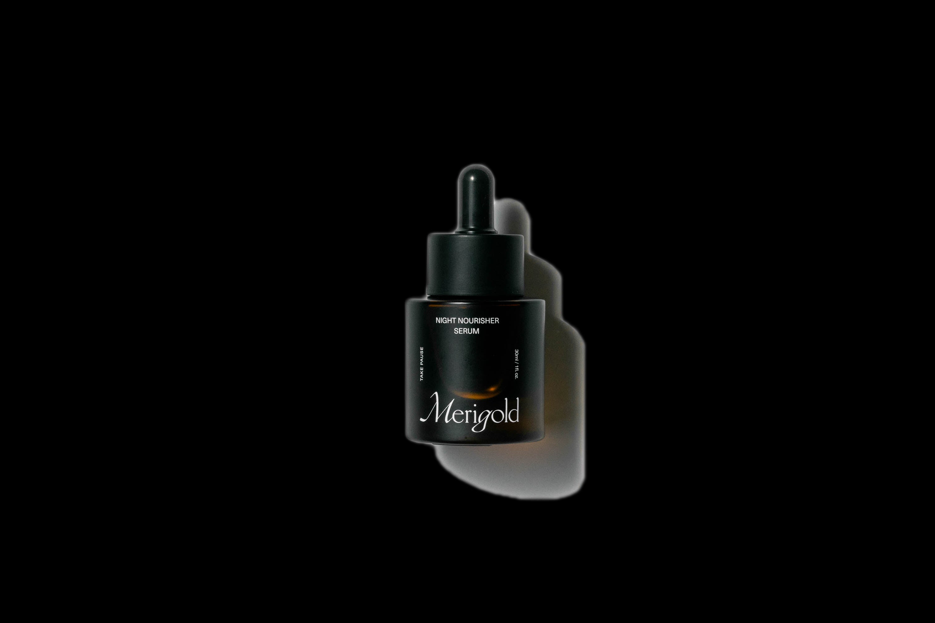 Merigold Night Nourisher Serum in dark glass dropper bottle with shadow — hydrating blue tansy night oil for calm, radiant skin