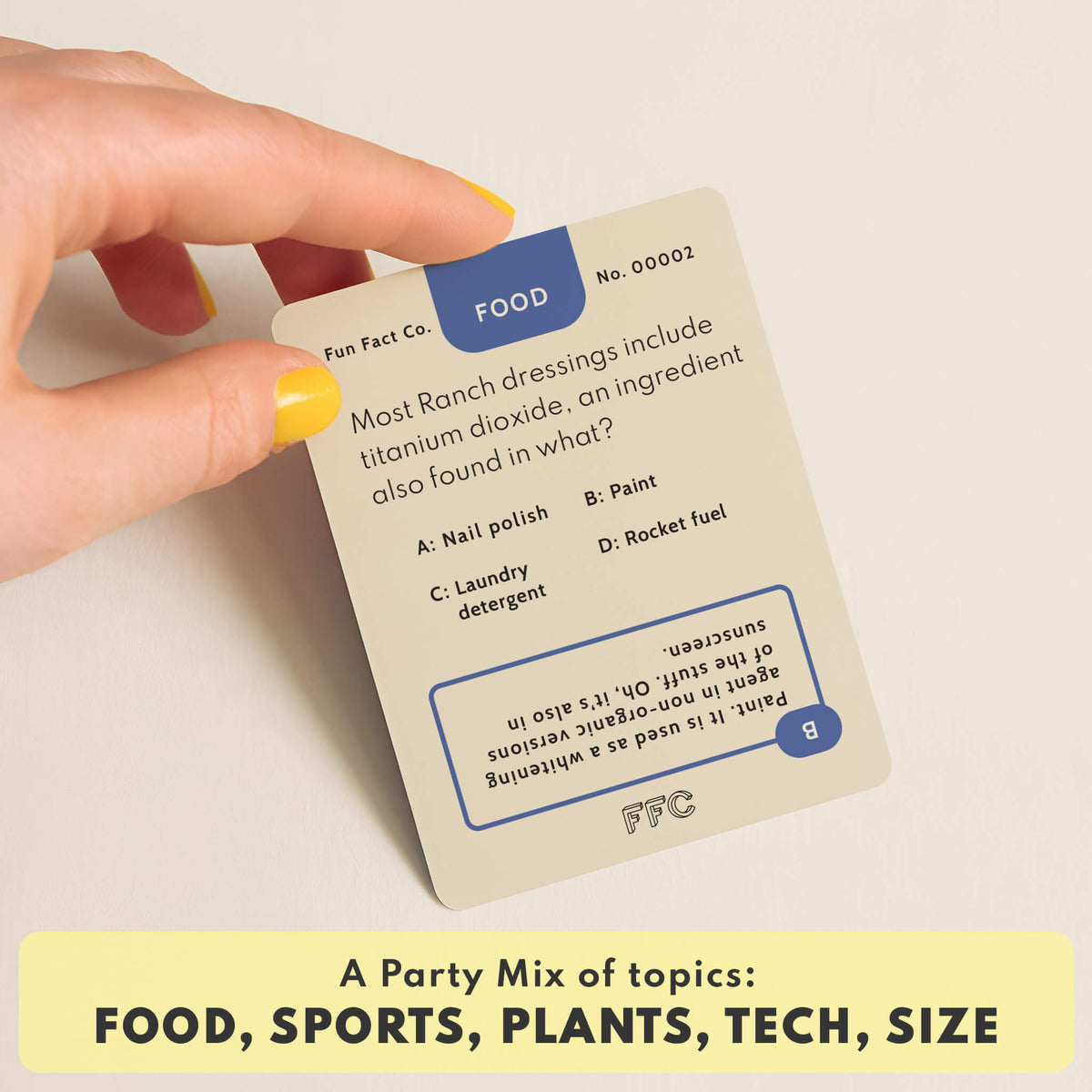 Card with trivia question about ranch dressings held by a hand, on a light background.