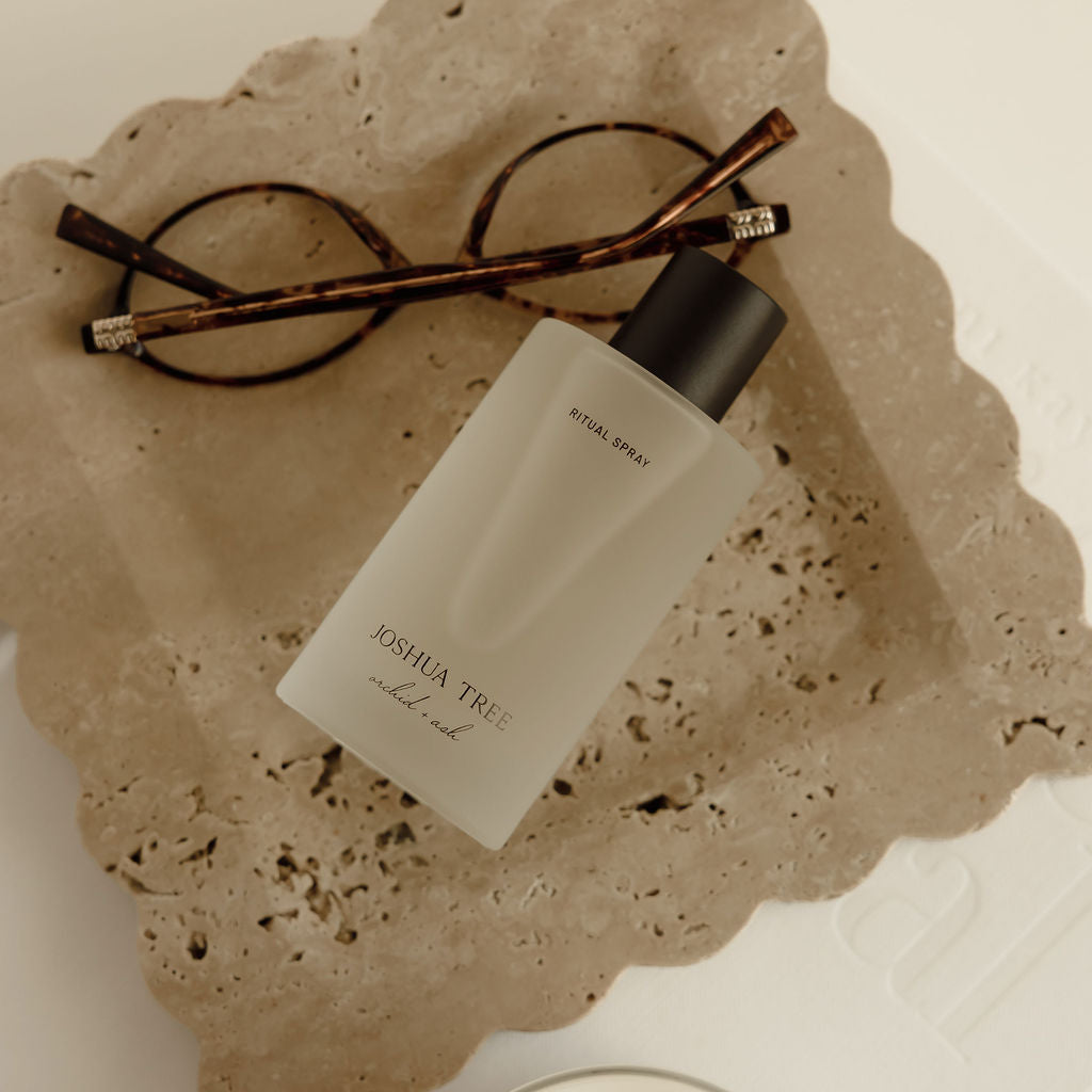Skincare product with wooden applicators on a textured stone surface