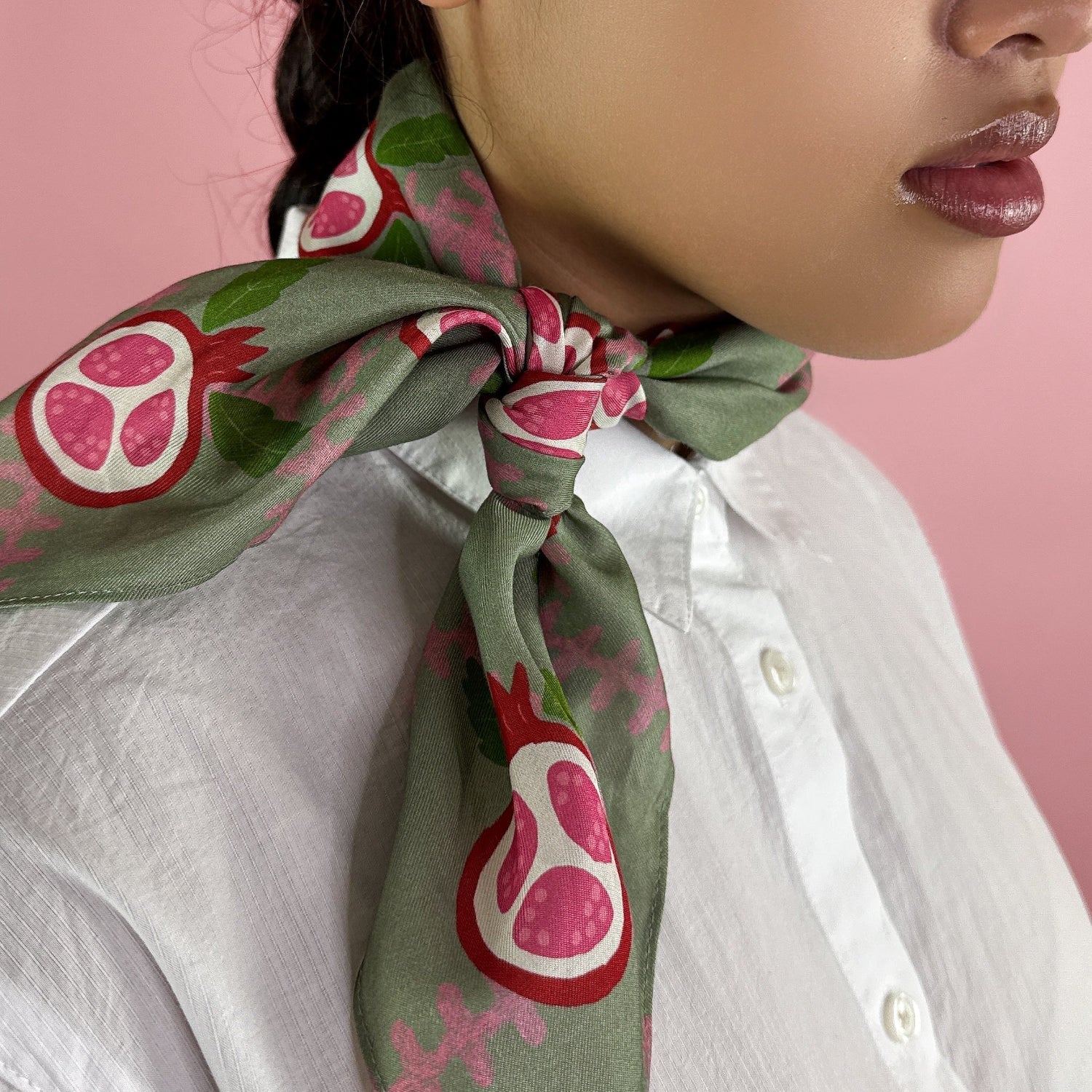 Fabric with pink pomegranate pattern on a green checkered background