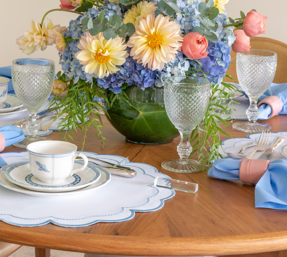 The blue Victoria impermeable placemat with Victorian-style border detail by Talah Home