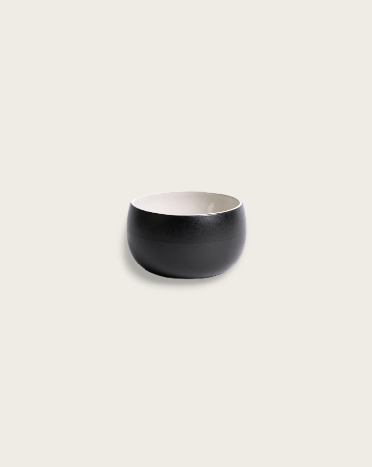 A stack of three white stoneware soup bowls of different sizes on a neutral background.