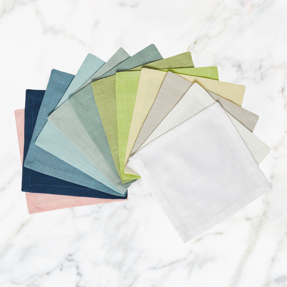 CNP-4901-X_1|Assorted colorful linen dinner napkins in a fan, offering a vibrant mix and match for diverse elegant table settings.