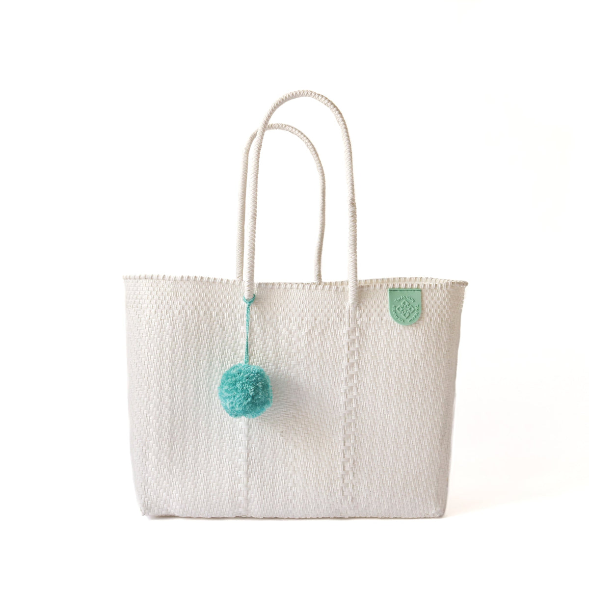Tin Marin super tote in Paloma Design, A white oversized tote bag with a pompom decoration, and a shoulder strap.