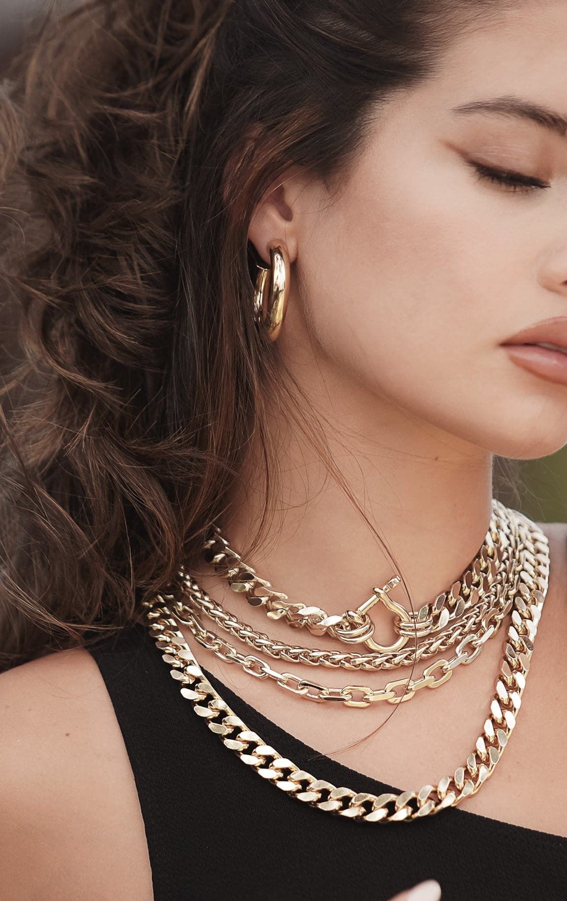 Woman wearing stunning Lennon Necklace with gold jewelry perfect for any outfit