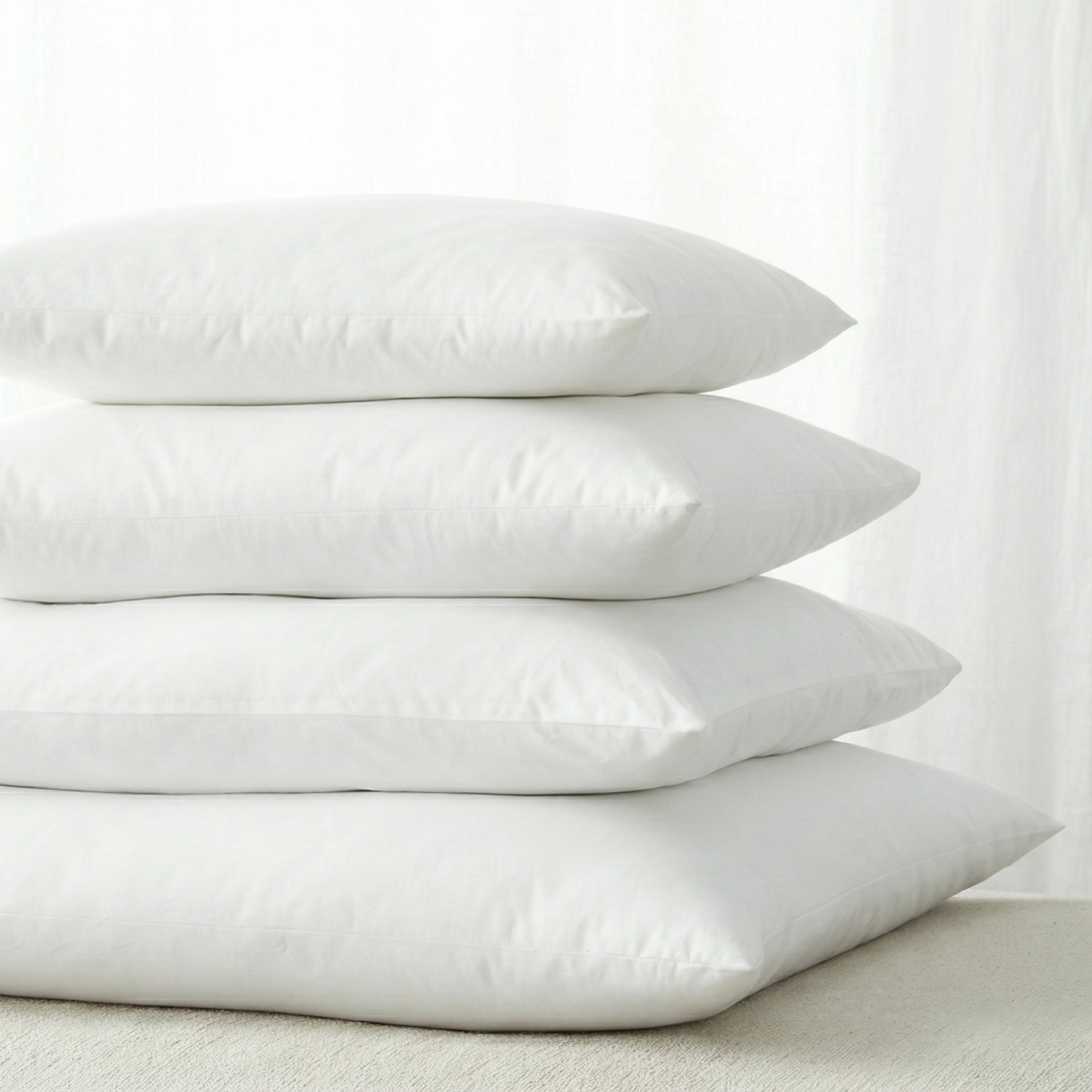 PI-2501-X_1|Stack of four soft white pillows, perfect for adding extra loft and support to any bed or providing decorative flair.