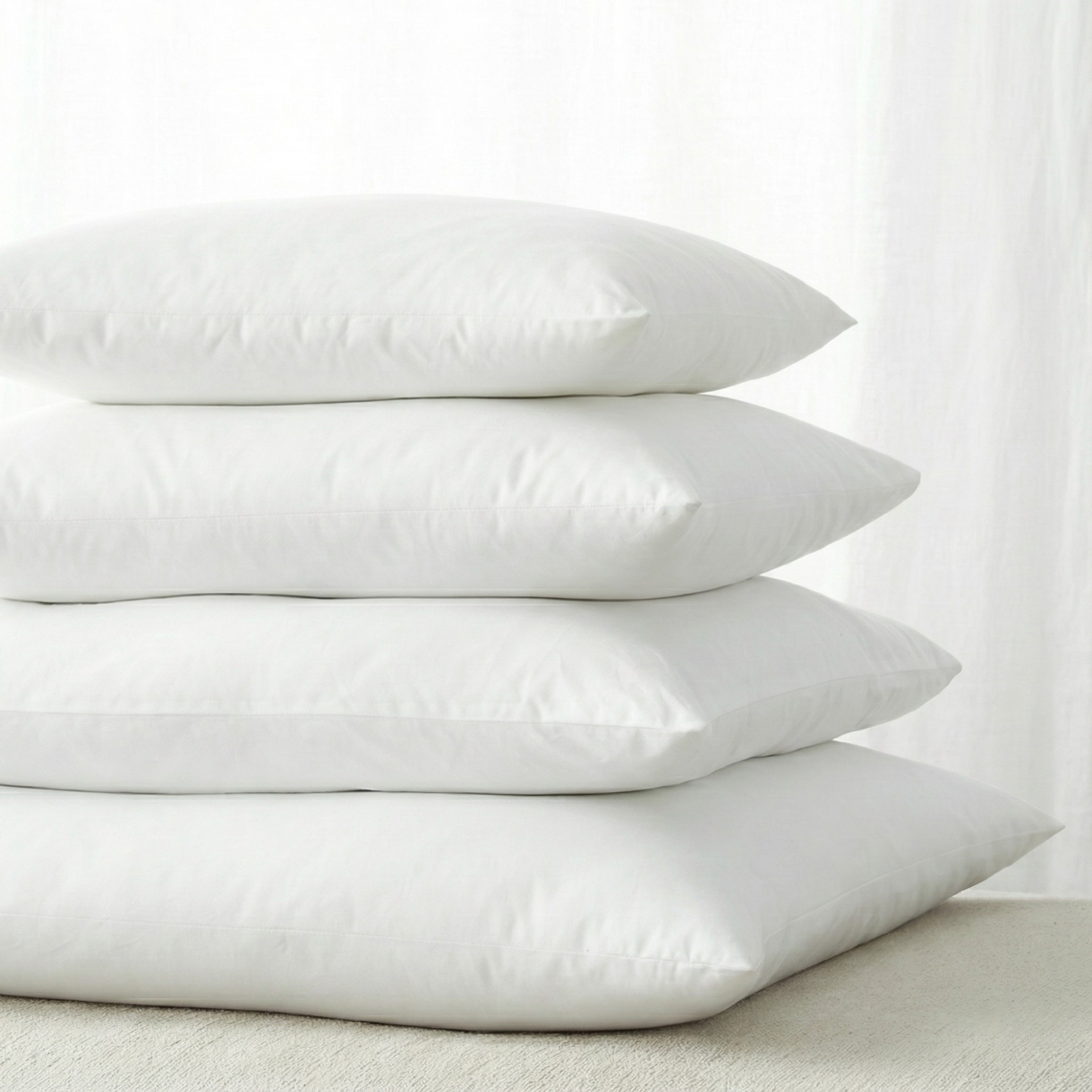 PI-2501-X_1|Stack of four soft white pillows, perfect for adding extra loft and support to any bed or providing decorative flair.