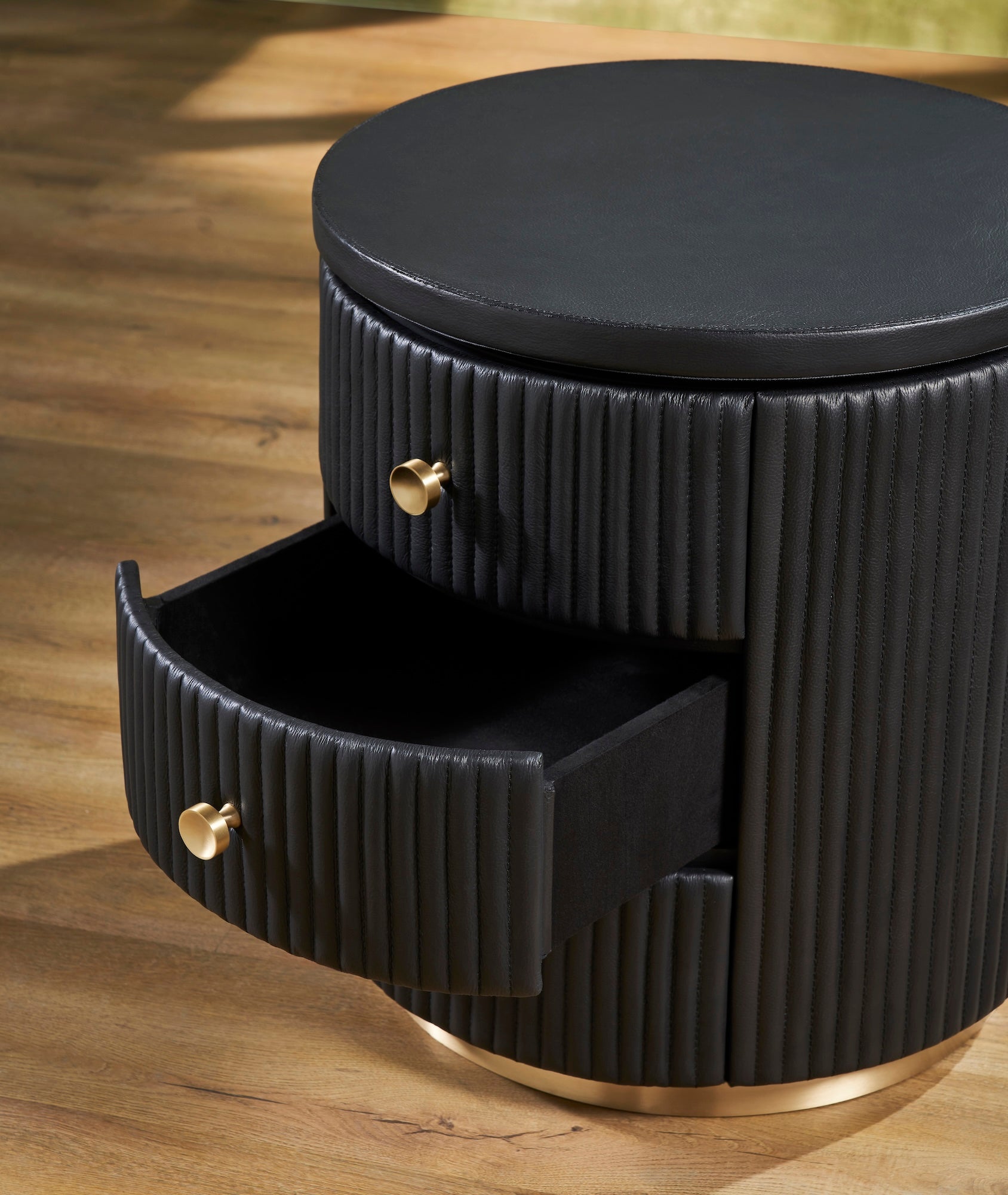 FN-5213-202022_4|Close-up of black fluted leather round nightstand with an open drawer, elegant and practical leather furniture.