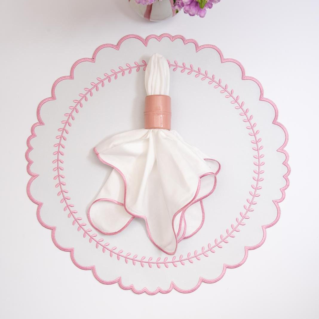 Arrow impermeable placemat with geometric border design in pink by Talah Home
