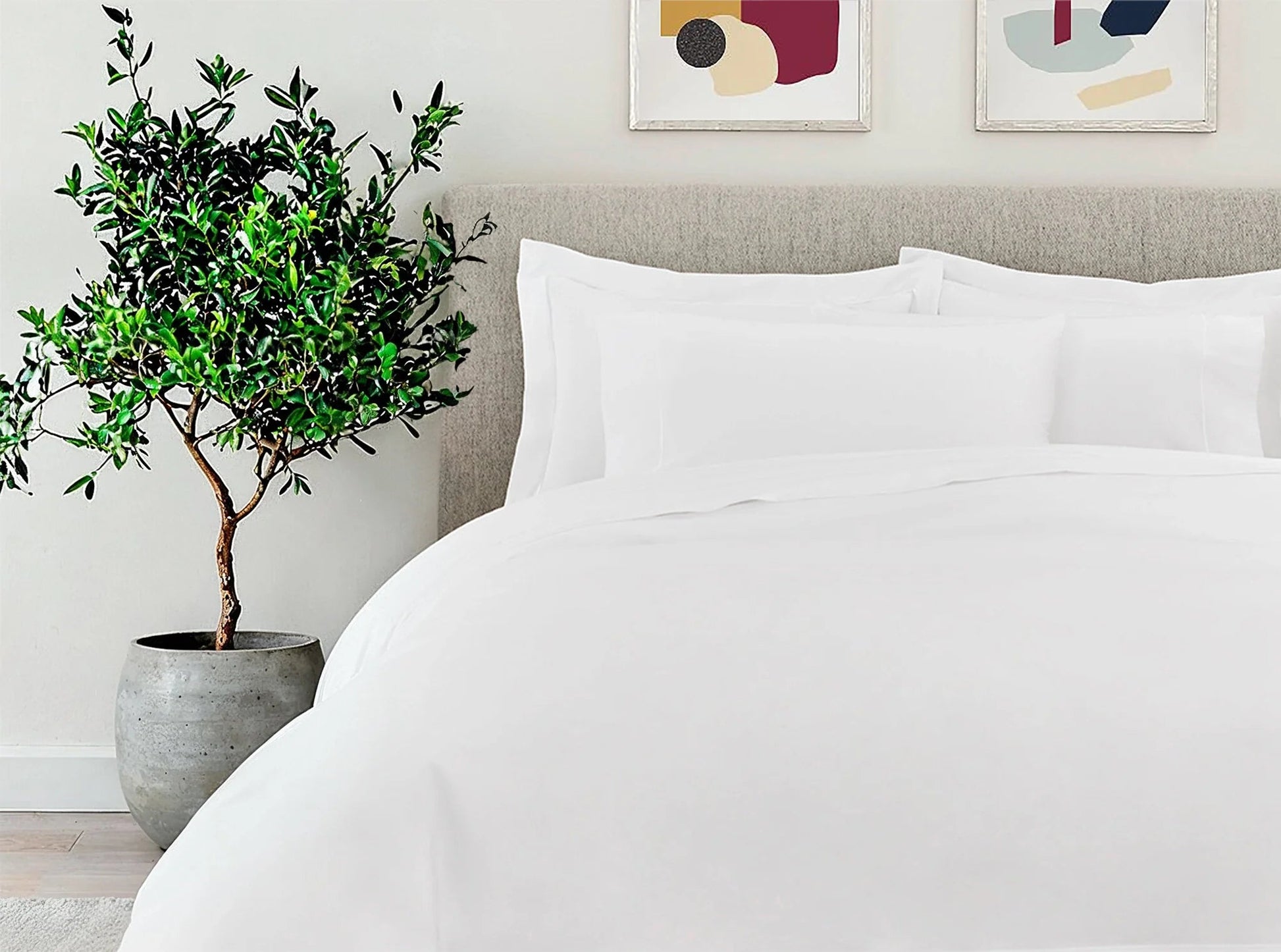 White organic cotton percale embroidered duvet cover and pillowcases on bed - crisp luxury bedding