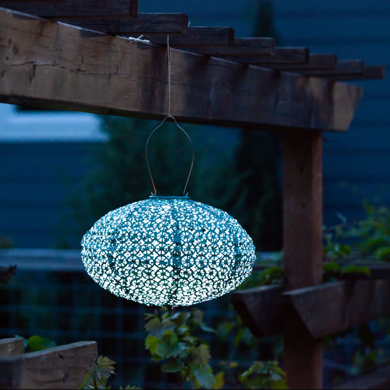 Soji Stella Oval Tyvek Solar Lantern glowing at night