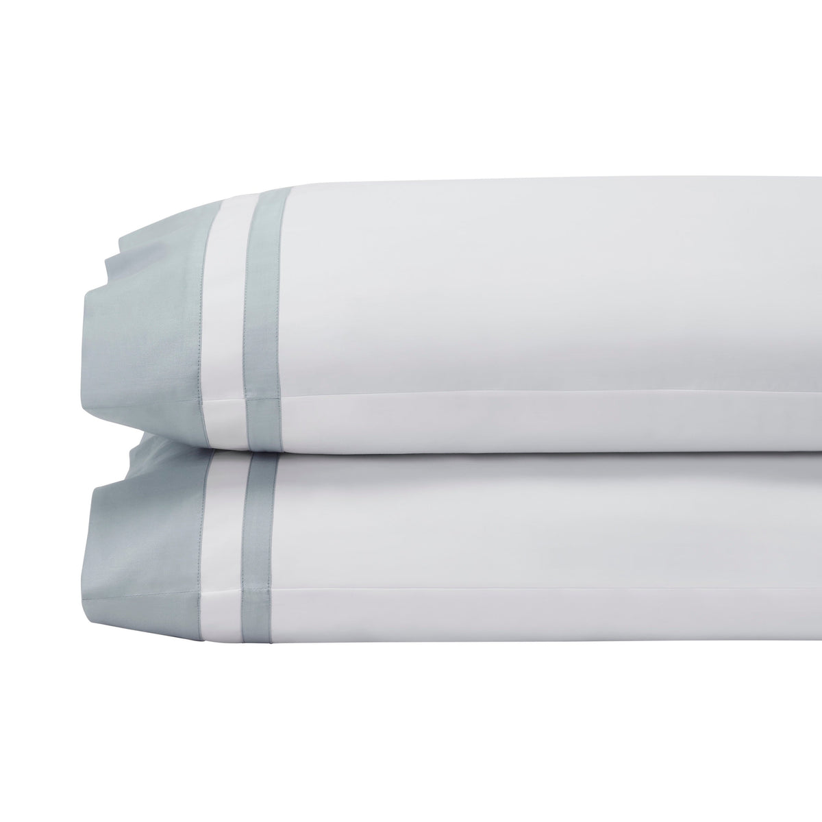 AKP-548-2040_4|Stack of folded 100% cotton sheets in various solid colors including beige, green, blue, and navy, with white stripes.