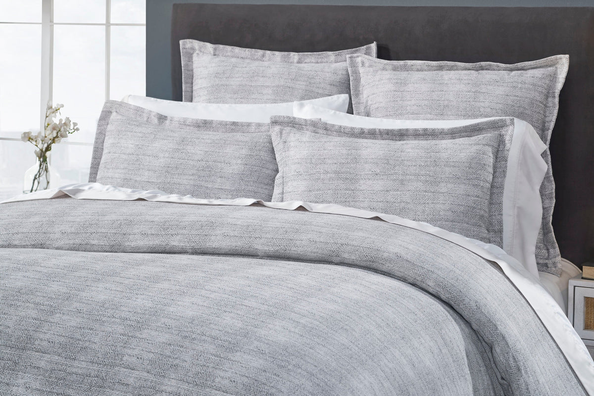 DT-035-9092_3|Close-up of a luxurious gray textured duvet cover and coordinating shams, highlighting the intricate woven pattern.