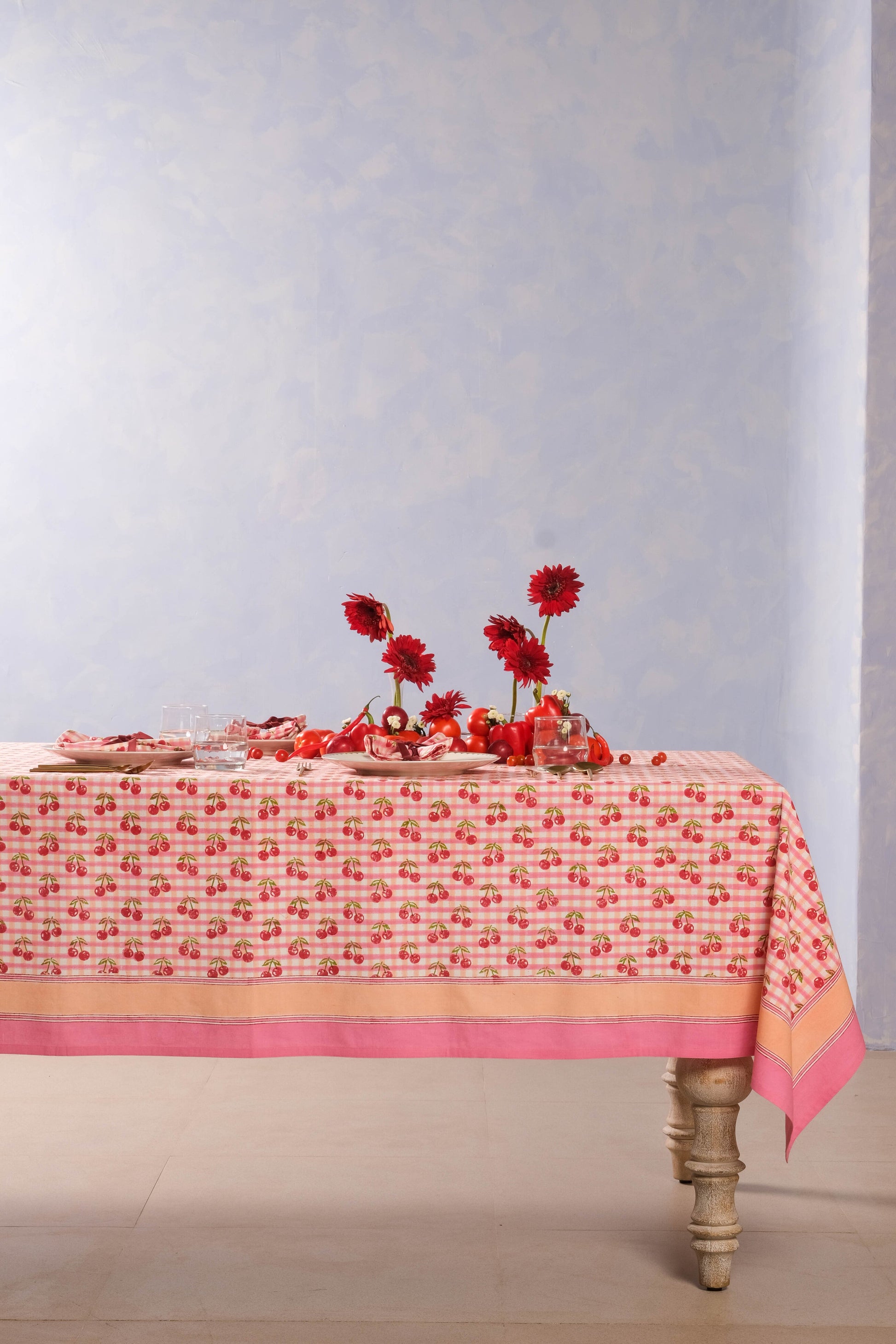 Cherry blockprint red gingham tablecloth with floral arrangement