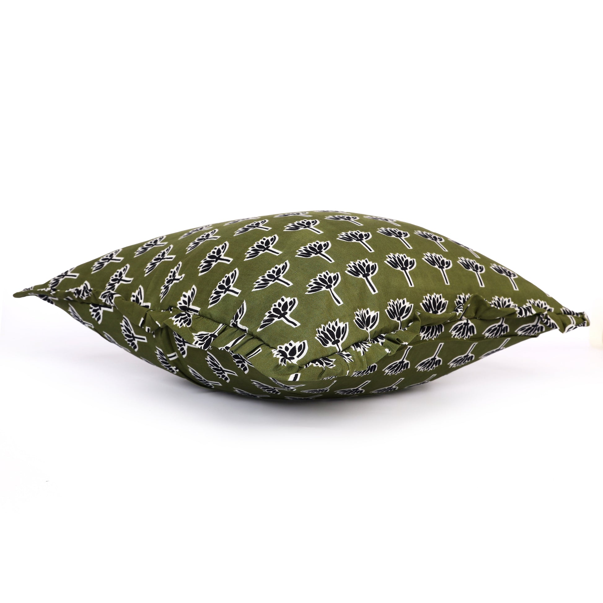 Dark green block-printed pillow on cushion seat