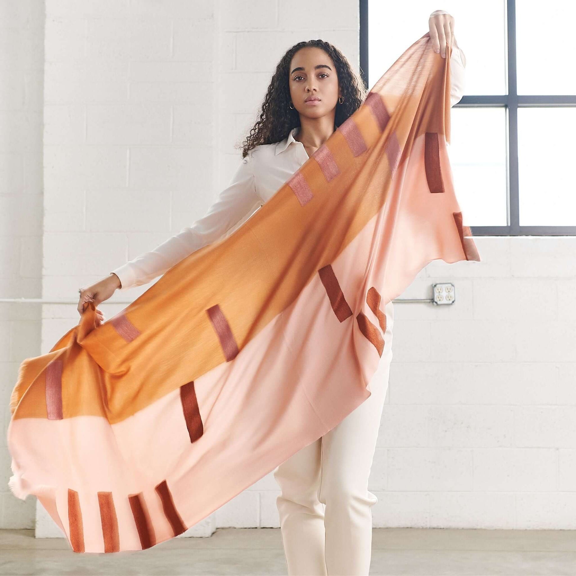 Canyon Hand Embroidered Hand Woven Merino Silk Soft Scarf displayed by a model in a light-filled studio.