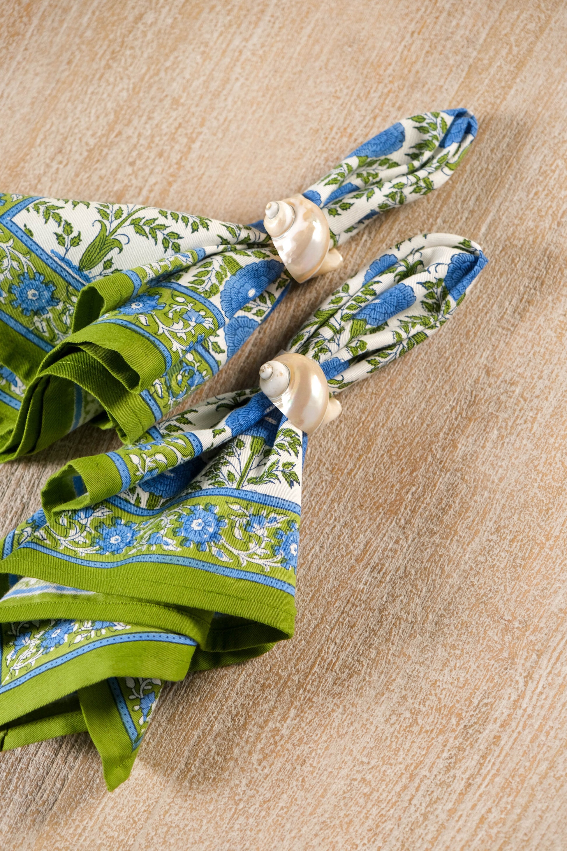 Blue araminta blockprint napkins tied with shell napkin rings