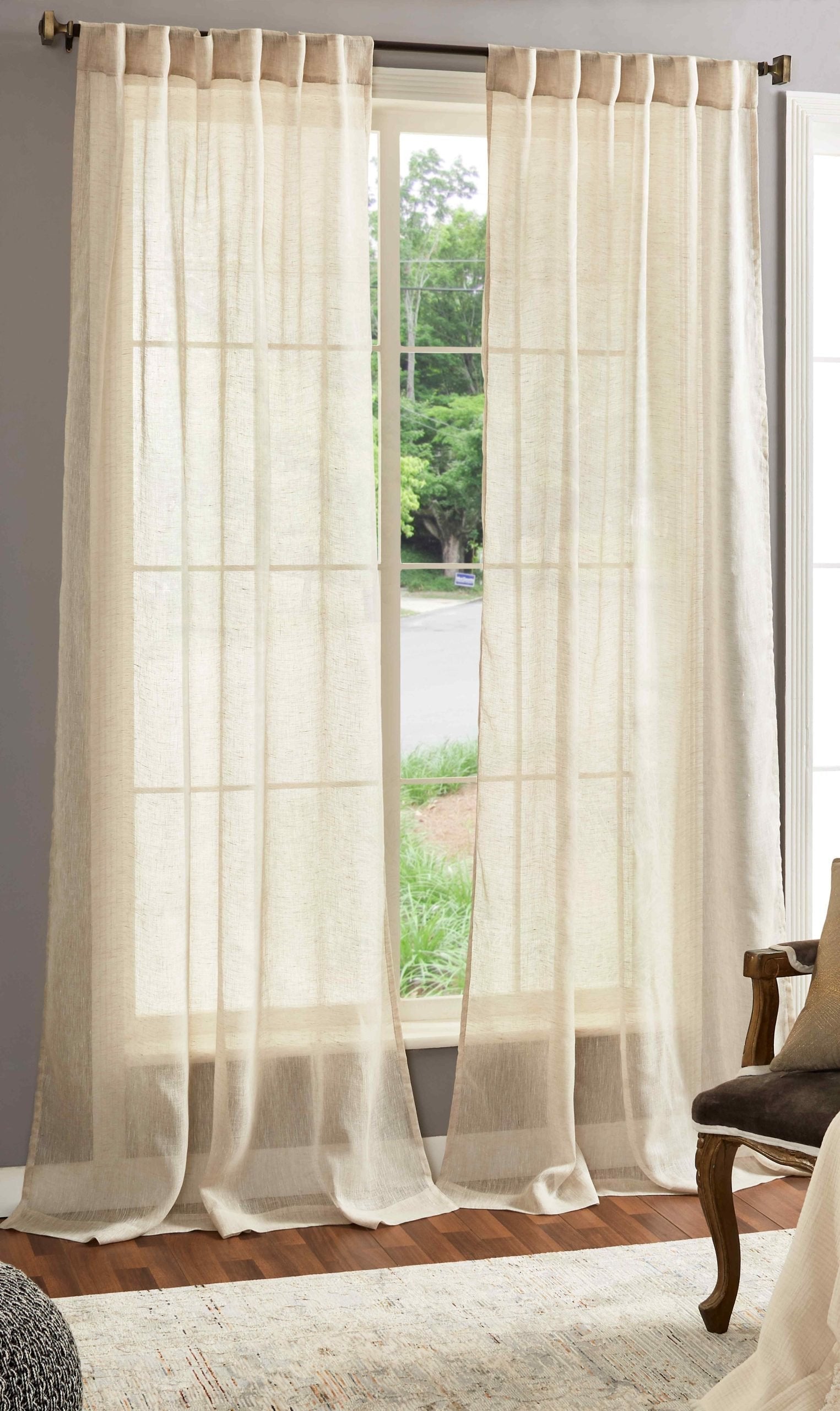 DY-709-5096_1|Two natural beige linen tab top curtains, sheer and flowing, framing a bright window for a light, airy room.
