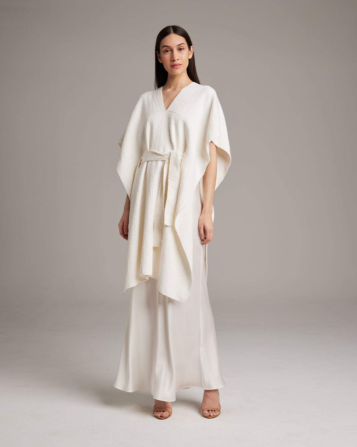 Model wearing a textured cotton solid kaftan over a slipdress